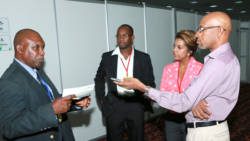 FAO technical advisor to the OECS, Reuben Robertson, speak with reporters at CWA 2014. 