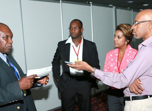 FAO technical advisor to the OECS, Reuben Robertson, speak with reporters at CWA 2014. 