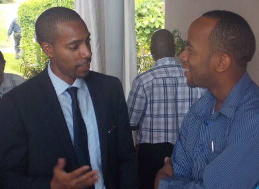 Columbus Communications SVG country manager, Christopher Gordon, and Sen. Luke Brown share a light moment