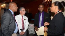 BDO's Floyd Patterson, left,  confer with bank officials after the formal presentations.