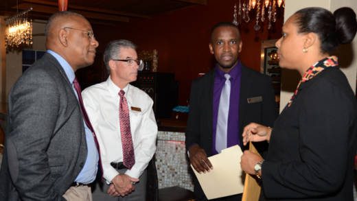 BDO's Floyd Patterson, left,  confer with bank officials after the formal presentations.