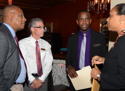 BDO's Floyd Patterson, left,  confer with bank officials after the formal presentations.