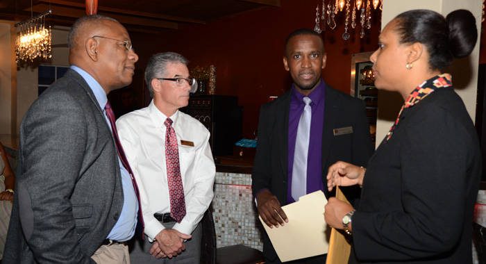 BDO's Floyd Patterson, left,  confer with bank officials after the formal presentations.
