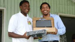 Sen. Camillo Gonsalves presents a laptop to a Community College student. (Photo: Facebook)