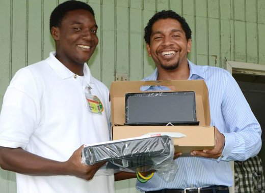 Sen. Camillo Gonsalves presents a laptop to a Community College student. (Photo: Facebook)