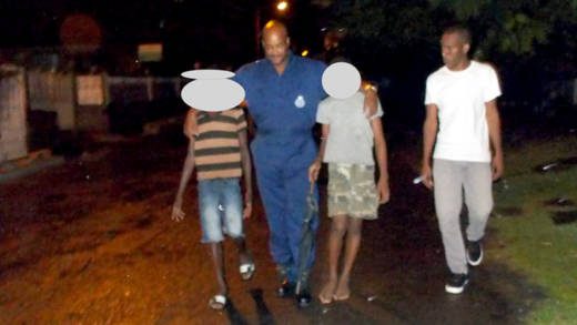 Fire fighters escort two of the boys from the scene. (Photo: Ashford Peters/Facebook)