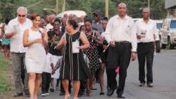 Director of NEMO, Howie Prince, second right, leads the candlelight march after the memorial service. (IWN Photo)