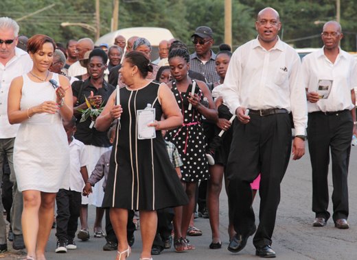Director of NEMO, Howie Prince, second right, leads the candlelight march after the memorial service. (IWN Photo)