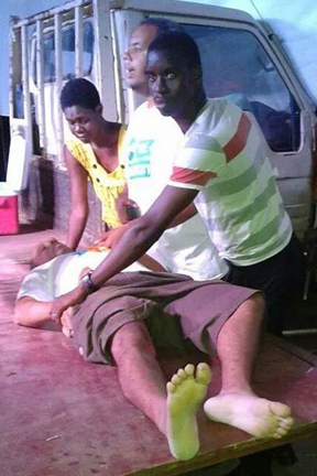 An injured man is assisted at the poltimeeing on Satur