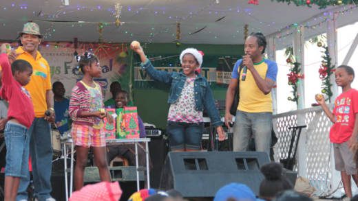 Children take part in a fruit-peeling competition at Nine Morning celebration in Kingstown. (IWN photo)