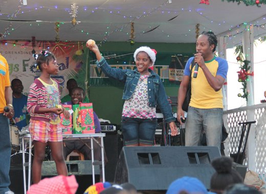 Children take part in a fruit-peeling competition at Nine Morning celebration in Kingstown. (IWN photo)