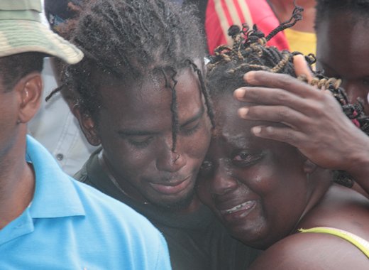 Relatives of one of the victims console each other at the scene on Monday.