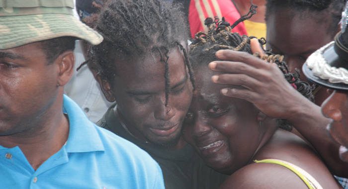 Relatives of one of the victims console each other at the scene on Monday.