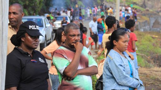 Station Sergeant Hesron Ballantyne, centre, whose daughter, Simonique Ballantyne, is missing, at Rock Gutter on Tuesday. (IWN photo)