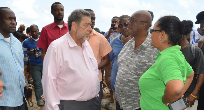 Prime Minister Dr. Ralph Gonsalves, centre, chats with Opposition Leader Arnhim Eustace and Sen. Vynnette Frederick at Rock Gutter on Monday. (Photo: Duggie "Nose" Joseph/Facebook)