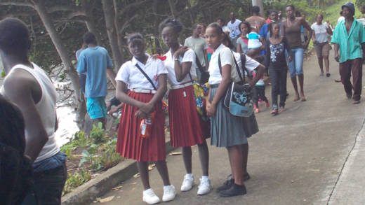 Secondary school students and other onlookers at the scene in Rock Gutter on Monday. (IWN photo)