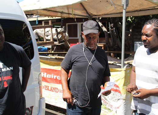 President of NOBA, Anthony "Code Red" Bacchus, centre, and two bus operators. (IWN file photo)