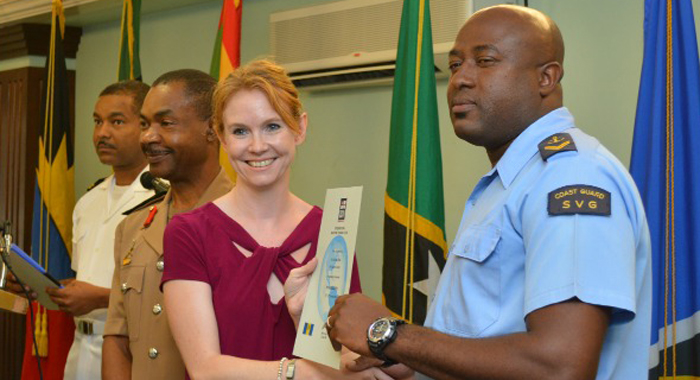 Clinton Lewis, right, from St. Vincent and the Grenadines receives his certificate of completion from Victoria Dean.