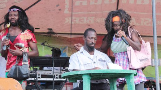 Maxwell "Tajoe" Francis, left, and other persons put on a skit in Fancy on National Hero's Day. (IWN photo)
