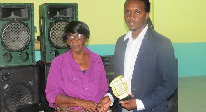 Commonwealth Queens Young Leaders Award winner Kenville Horne receives and award from community activist and businesswoman Anesta Rodney, MBE.