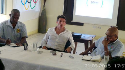 TASVG President Keith Joseph, left, and NOC Chairman, Trevor Bailey, right, listen to Lord Coe's presentation. (Photo: E. Glenford Prescott)
