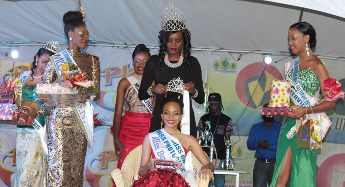 Miss Easterval 2015 Miss Barbados Ieashia Browne  is crowned by the 2014 winner of the crown, Miss Union Island Phillis Denbar. First Runner-up,  Miss St. Vincent Nikianna Williams is at left, and   Second Runner-Up, Miss Grenada Deronna Farray at right. (IWN photo) 