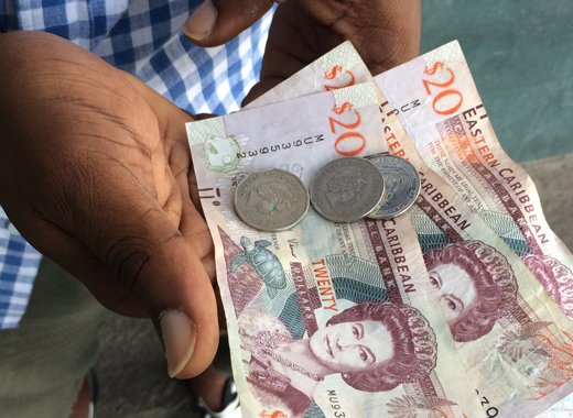 Sean Jack this week converted to larger denominations the EC$63 in pennies he picked up across SVG over the past half year.  (IWN photo)