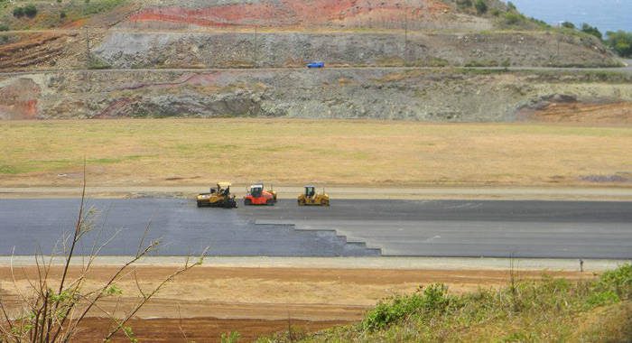 Workers are almost mid-way with the placement of the first layer of asphalt in the 2nd kilometer of the runway. (Photo: Friends of AIA/Facebook) 