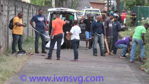 Homicide investigators process the scene in Campden Park where Aljay Douglas was shot dead. (IWN photo)