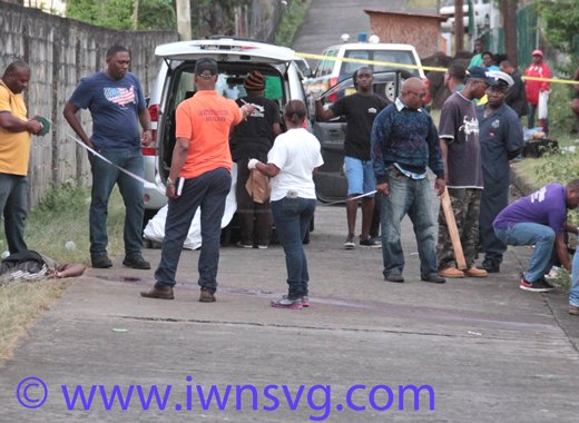 Homicide investigators process the scene in Campden Park where Aljay Douglas was shot dead. (IWN photo)