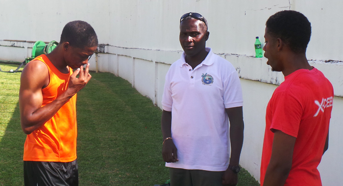 Coach Garth Deshong, centre,  with the Boyde twin at the start of training session at Victoria Park. (Photo: E. Glenford Prescott) 