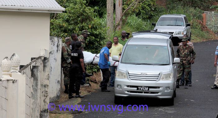 Police and funeral home staff remove Primus' body from the scene in New Montrose on Thursday. (IWN photo)