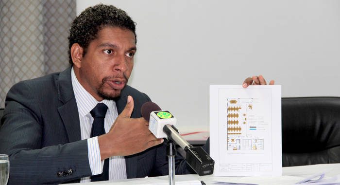 Minister of Technology Sen. Camillo Gonsalves holds up the floor plan of the call centre that Digicel will open in SVG.  (IWN photo)