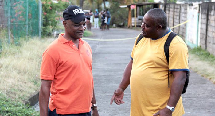 ASP Sydney James, left, and Inspector Trevor Bailey investigate a murder on Friday. They have both been transferred. (IWN photo)