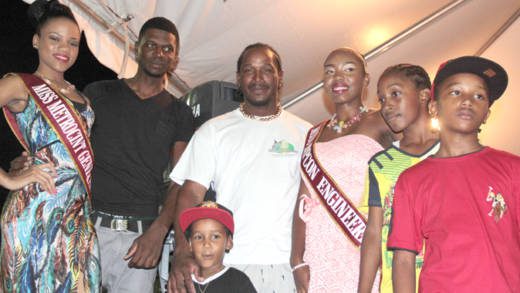 Fisherman of the Year 2015 Ray Anthony Clarke , centre, along with his children, crew member and Miss SVG contestants. (IWN photo)