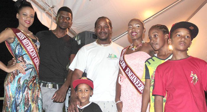Fisherman of the Year 2015 Ray Anthony Clarke , centre, along with his children, crew member and Miss SVG contestants. (IWN photo)