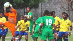 Dominica 'keeper Elijah Toulon goes high to avert danger. (Photo: E. Glenford Prescott/IWN)