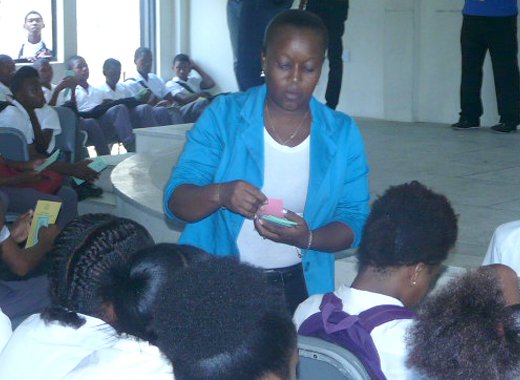 Police Constable Karla Timm distributing crime tips brochures to students of the Sandy Bay Secondary School.
