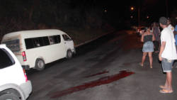 Rillan Hill resident look on as a minivan prepares to take the injured man to hospital Sunday night. (IWN photo)