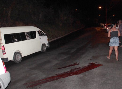 Rillan Hill resident look on as a minivan prepares to take the injured man to hospital Sunday night. (IWN photo)
