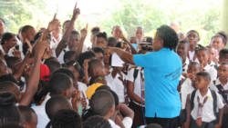 A police officer interacts with students during the anti-crime tour of secondary school.