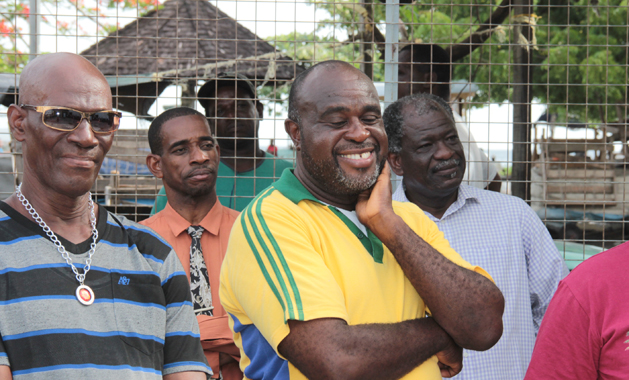 Businessman Leon "Bigger Bigs" Smauel, centre, a the opening of his business, Pheonix Chicken in Kingstown. (IWN photo)