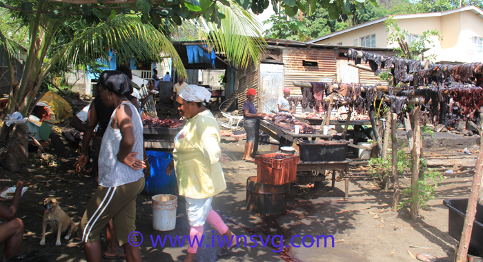 Persons involved in various activities surrounding the processing of whale meat and oil on Sunday. (IWN photo)