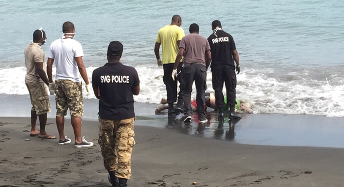 Police retrieve the body after it washed ashore on Wednesday. 