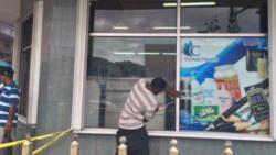 A man replaces the damaged window at Coreas City store on Tuesday. (IWN photo)