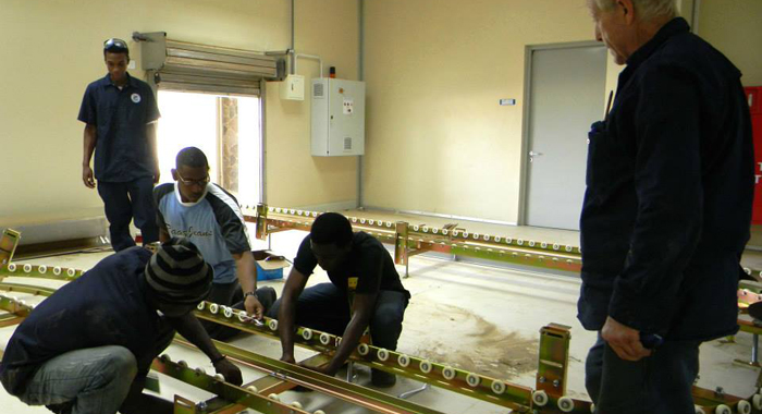 Workers install the baggage carousel in the terminal building, which was build two years ago. (Photo: Friends of Argyle Int'l/Facebook) 