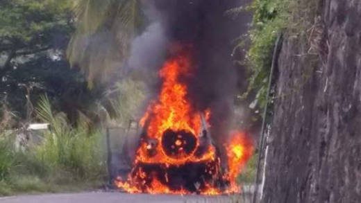 The vehicle engulfed in flames in Layou. 
