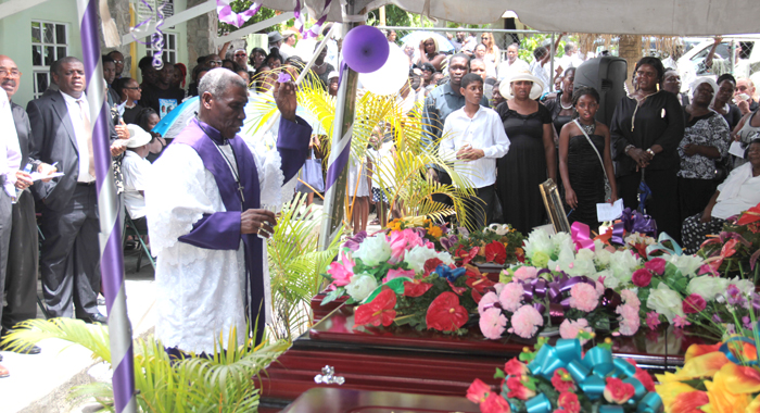 Bishop Ashton performs rites at the funeral in Spring Village on Sunday. (IWN photo)