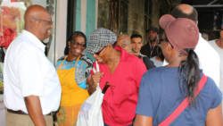 Opposition Leader Arnhim Eustace, left, interacts with persons in Kingstown on Friday. (Photo: NDP/Facebook)