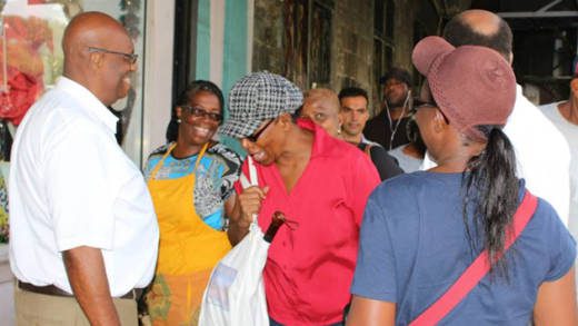 Opposition Leader Arnhim Eustace, left, interacts with persons in Kingstown on Friday. (Photo: NDP/Facebook)